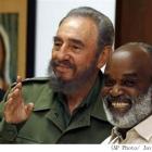 Rene Preval smiles as he is welcomed by Cuban President Fidel Castro